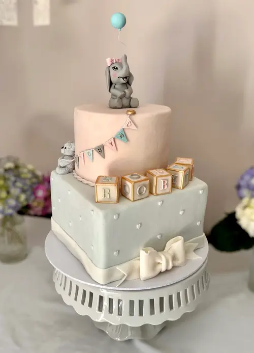 Pastel-decorated baby shower cake