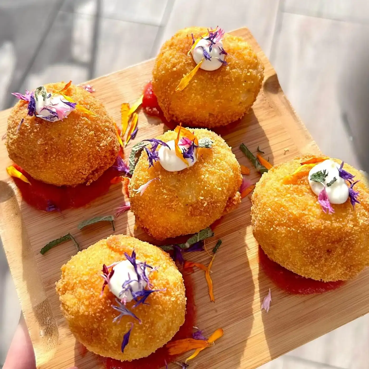 Arancini bites with edible flowers from Belinda's Bakery catering