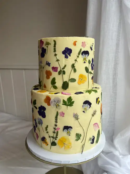 Elegant cake decorated with pressed flowers