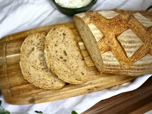 Sliced sourdough loaf on a wooden board